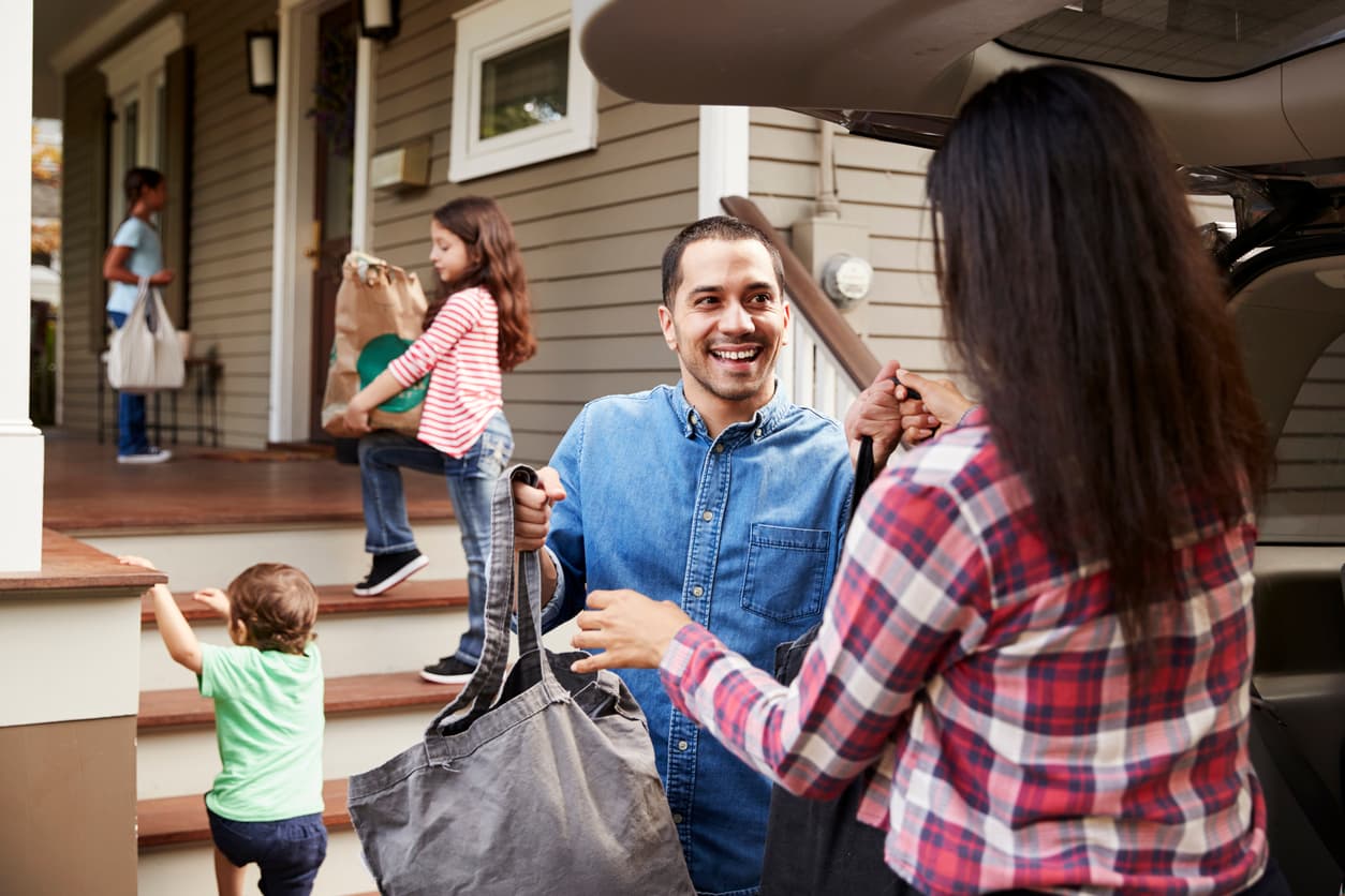 Community members exchanging fresh groceries showing the positive impact of digital food assistance programs powered by iQpay